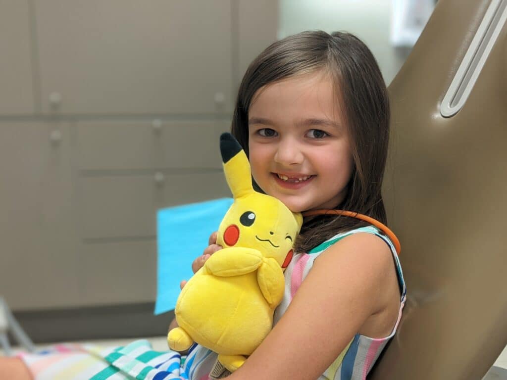 Girl and Pikachu waiting for hygiene cleaning